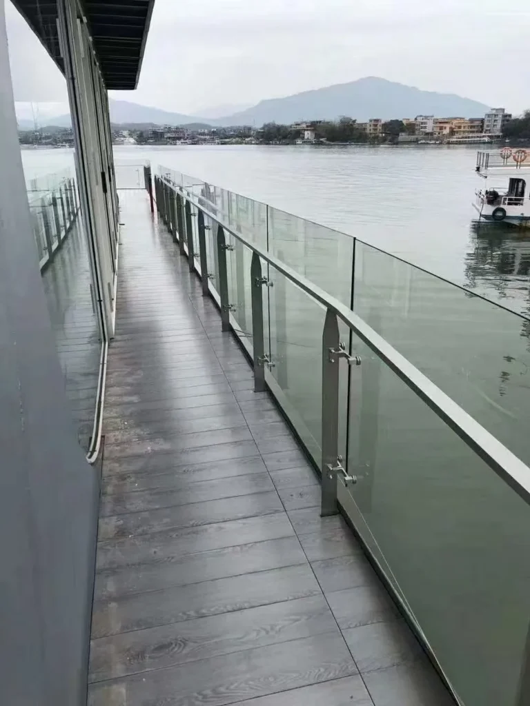 Installed flat-bar stainless steel glass railing posts on a waterfront project