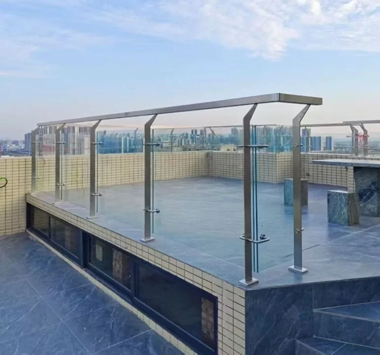 Installed stainless steel posts supporting a glass balcony railing and square handrail