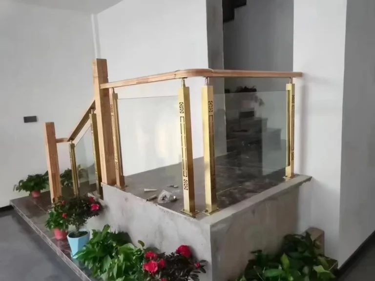 Gold decorative stainless steel glass railing posts showing a reflective surface finish