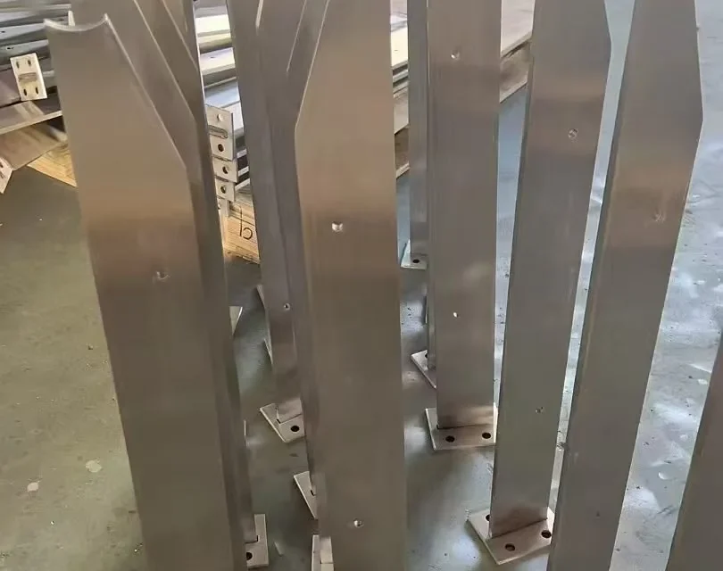 Batch of notched flat-bar stainless steel railing posts with shaped handrail interfaces