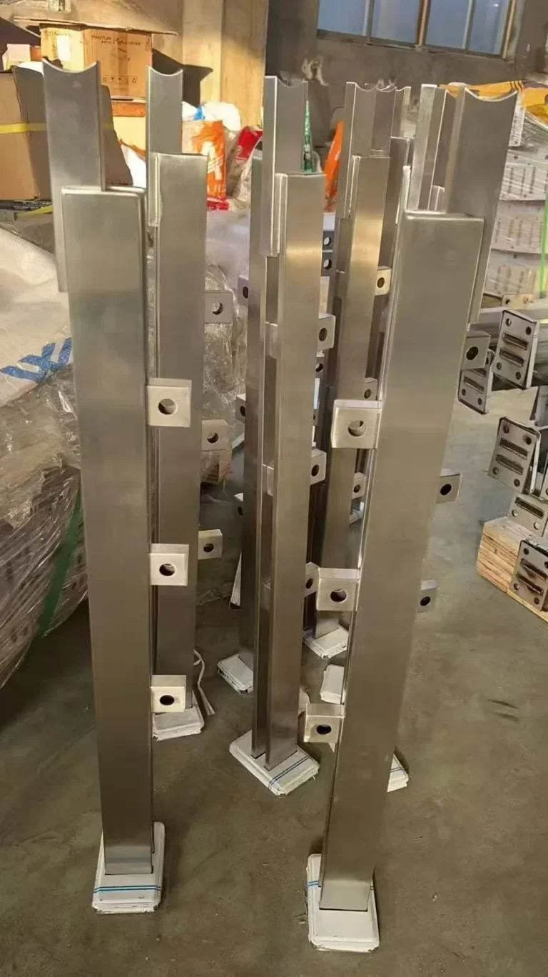 Batch of square stainless steel railing posts with welded glass adapters awaiting quality inspection