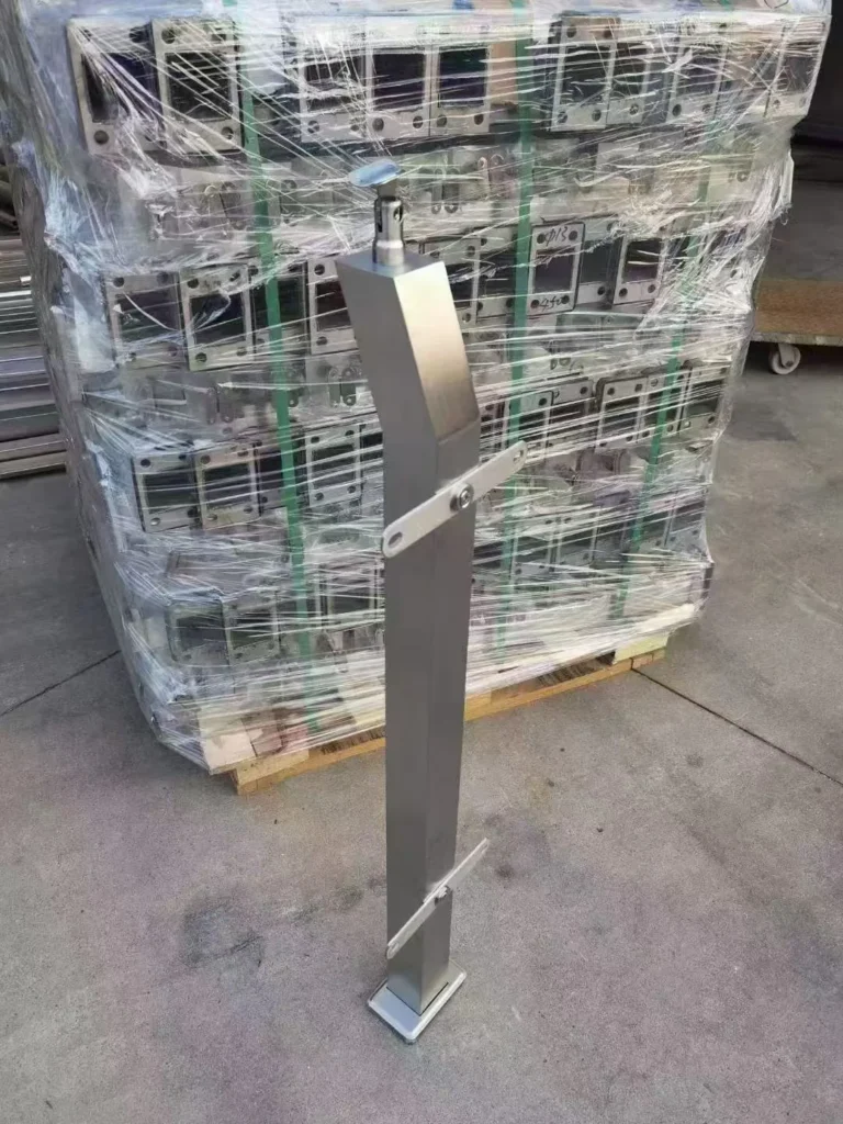 Finished stainless steel railing post beside a wrapped production batch prepared for quality and shipment review
